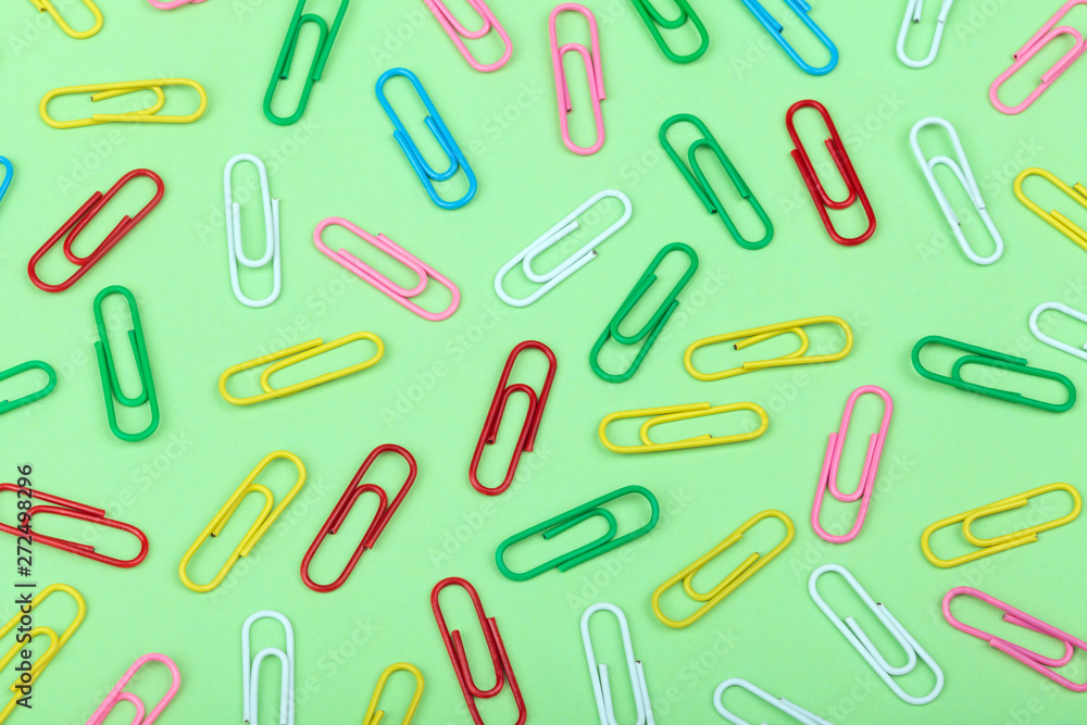 Colorful Paper Clips on Green Colorful Paper Clips on Green