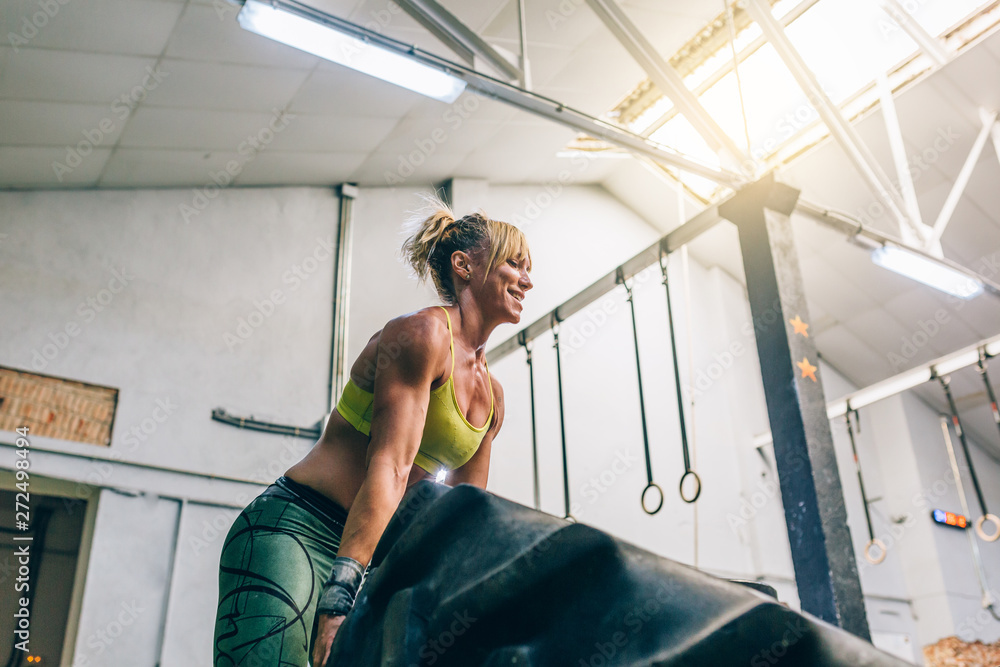 Muscular woman lifting car tire Stock Photo Adobe Stock