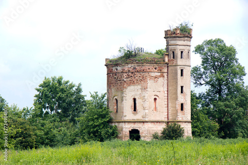 Small ruined abandoned castle overgrown in vegetation