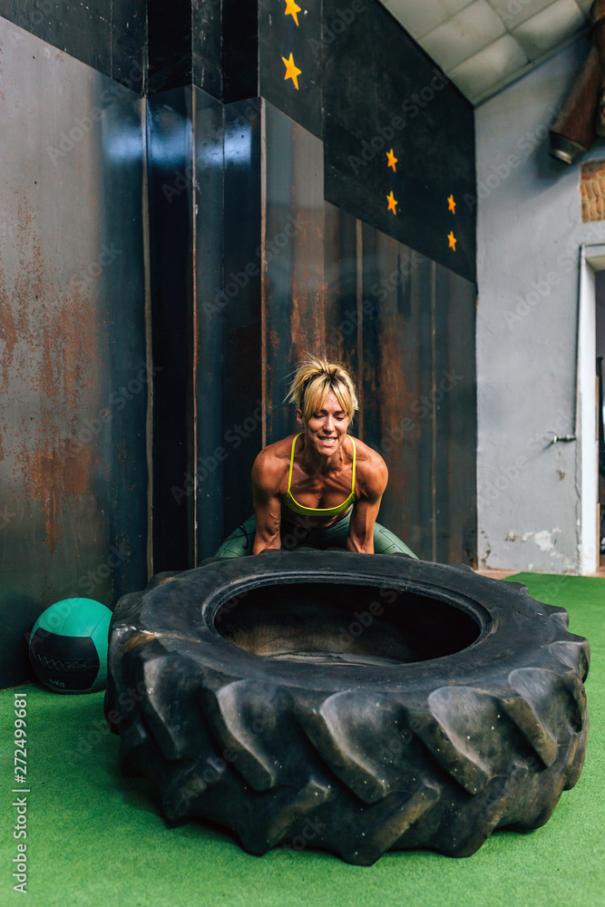 Muscular woman lifting car tire Stock Photo Adobe Stock