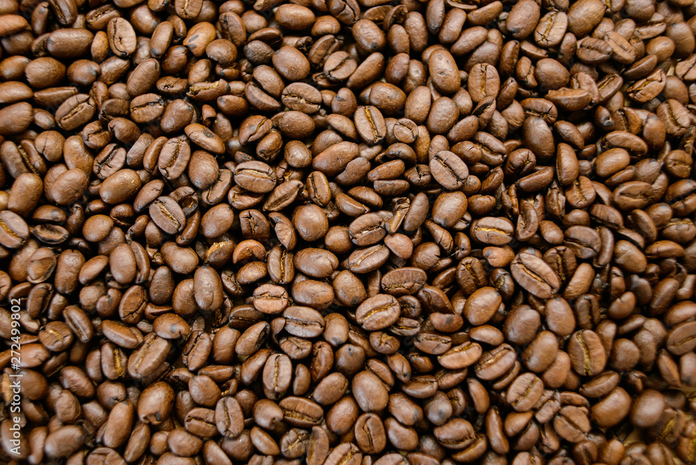 Roasted coffee beans on rustic wooden table background Roasted coffee beans on rustic wooden table background