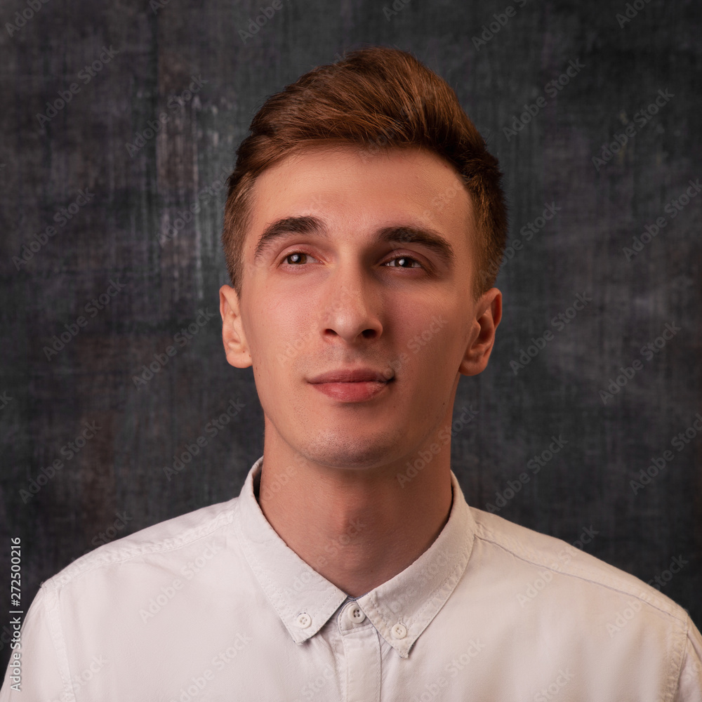 Portrait. Young handsome man with thoughtful dreamy expression. Good mood. Portrait. Young handsome man with thoughtful dreamy expression. Good mood.