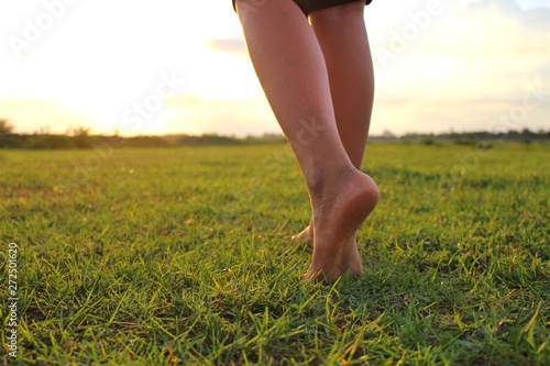 The beauty of the meadows and golden yellow skies in the evening, the children strolling on the lawn in low light, filmed as blurred images.