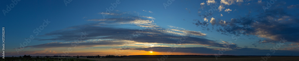 An amazingly beautiful panoramic sunset over the fields