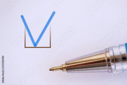 blue checkmark in questionnaire, number of blue pen close up