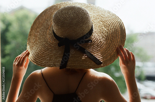 Back view of a woman with straw hat