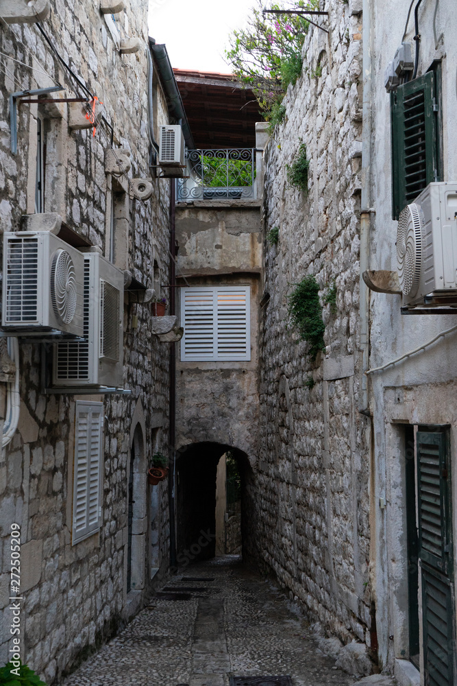 Medieval houses in the narrow streets of Dubrovnik with hanging clothes and stone stairs