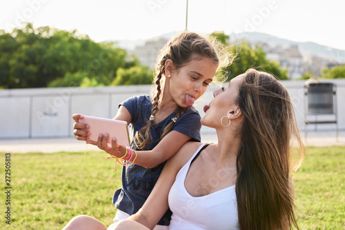 Sisters taking selfie with tongue out. photo