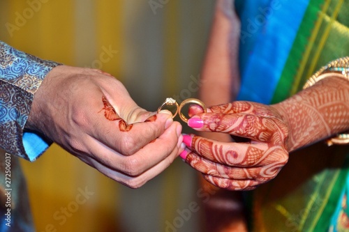Maharashtrian Wedding Ritual - Sakharpuda (Engagement) ritual - An Indian bride and groom holding rings in their hands during a Hindu ring ceremany, Soft focus photo