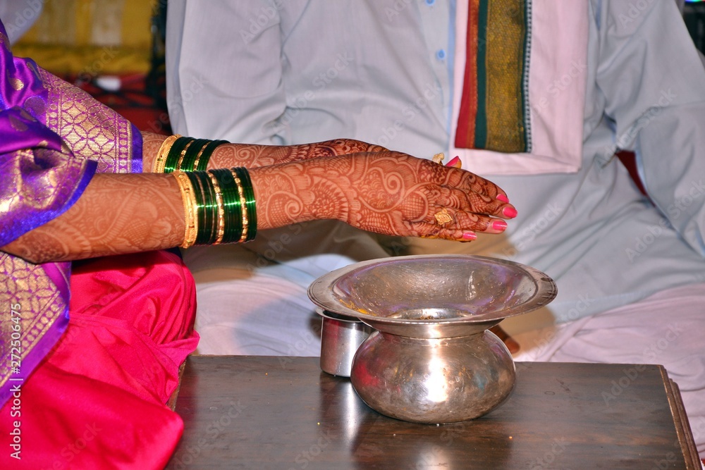 Maharashtrian Wedding Ritual Bride rubbing kankan or halkund with