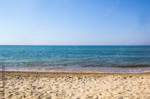 Seascape of sand shore and waves of Black sea