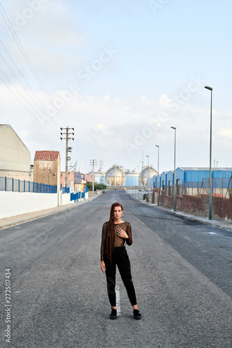 Woman in transparent shirt on empty road. photo