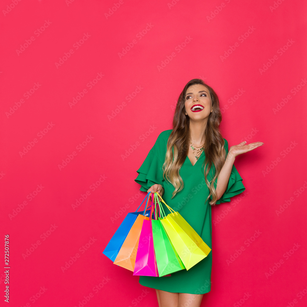 Beautiful Elegant Woman Is Holding Colorful Shopping Bags, Laughing And Looking Away