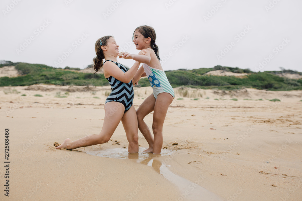 Girls playing in the shallow water on the beach Girls playing in the shallow water on the beach