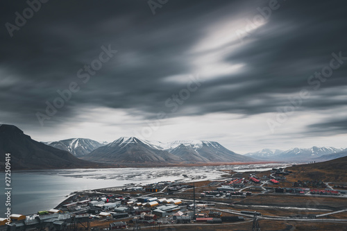 Svalbard mountain landscape, view from above Longyearbyen at Adventdalen Fjord in late autumn with dark clouds, moody look