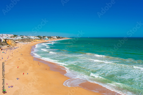 Aerial view on beach and Coast of Atlantic Ocean against blue sky in Albufeira, Algarve Portugal 