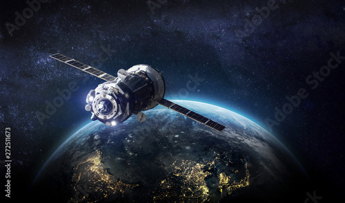 Fototapeta Naklejka Na Ścianę i Meble -  Space craft in outer space near Earth planet. Elements of this image furnished by NASA