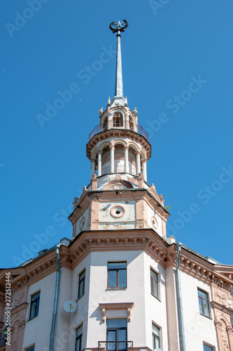 Part of the facade of the old building with a spire and a star, Stalin's Empire, Minsk,Windows and balconies, figured stucco