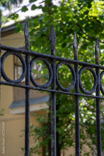 Wrought-iron black Fence-grille in front of the old house