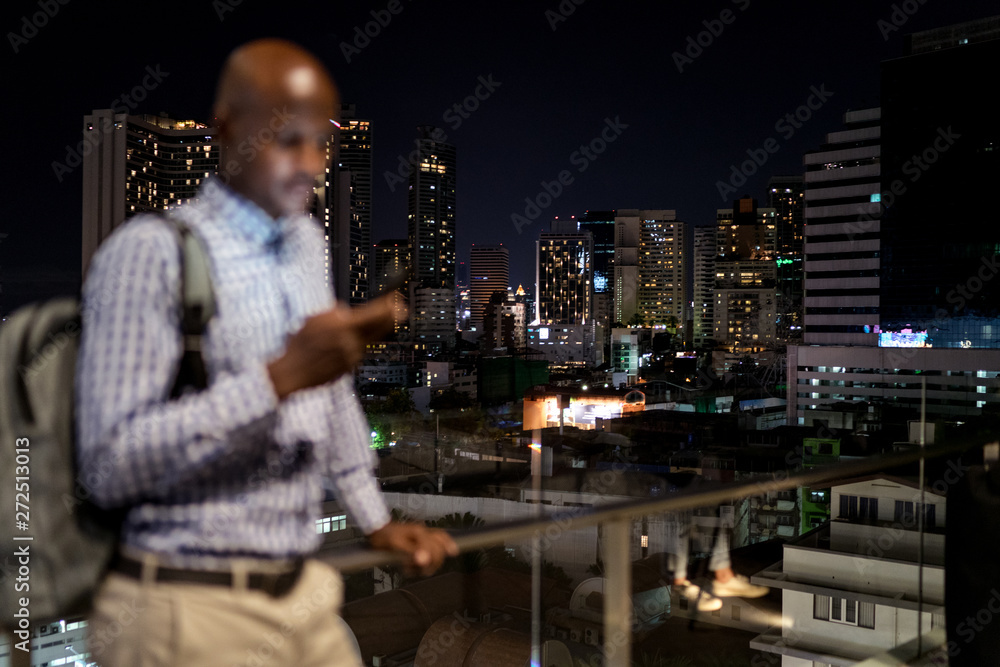 Man using his phone at night