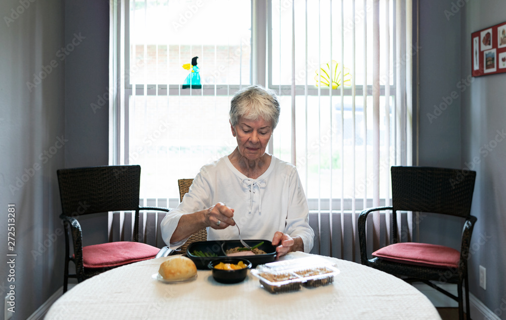 Meal: Woman Eating Dinner That Was Delivered By Volunteer Meal: Woman Eating Dinner That Was Delivered By Volunteer