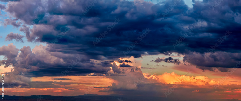 Dramatic light through the clouds against the backdrop of an exciting, bright stormy sky at sunset. panorama, natural composition Dramatic light through the clouds against the backdrop of an exciting, bright stormy sky at sunset. panorama, natural composition