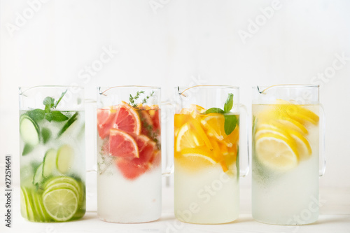 Refreshing lime, lemon, red grapefruit, peach, kiwi and cucumber infused water photo