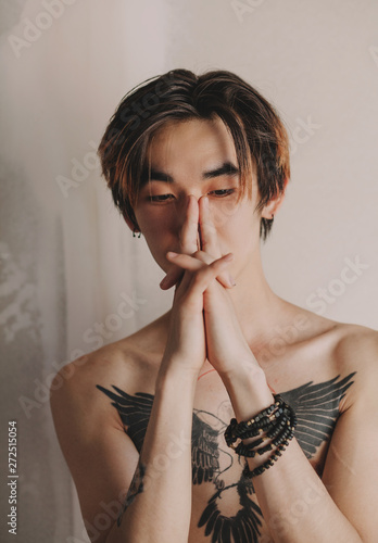 Asian man making sign with arms photo