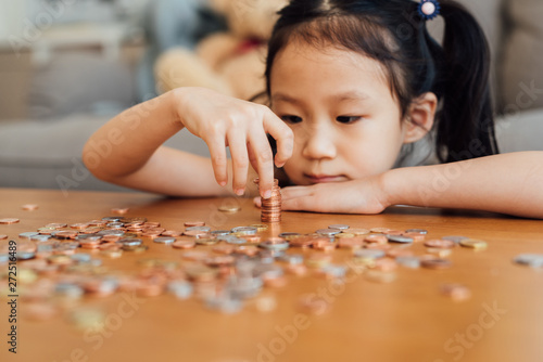 Little girl counting coins photo