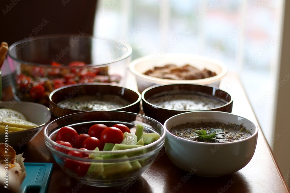Table setting with galette, snacks, dips and salads. Selective focus. Table setting with galette, snacks, dips and salads. Selective focus.