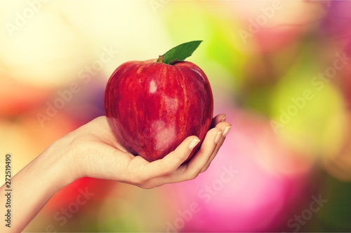 Woman hand holding big red apple