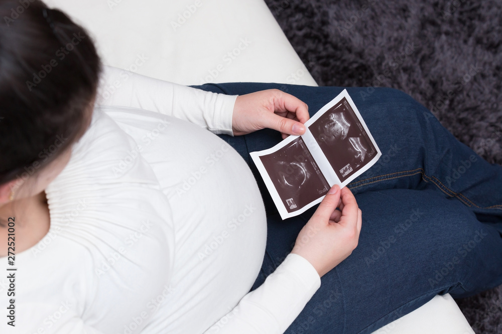 Expectant Mom Looking at Her Child’s Ultrasound Expectant Mom Looking at Her Child’s Ultrasound