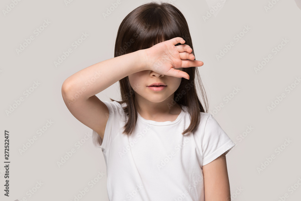 Little girl touch forehead with hand feeling unhealthy studio shot Little girl touch forehead with hand feeling unhealthy studio shot