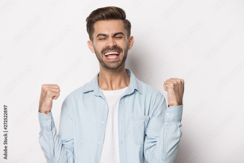 Man excited by good news lucky successful winner studio shot