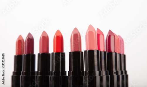 Lipstick with red flowers on white background. 