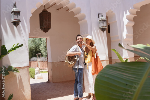 Cheerful couple exploring Moroccan villa and gardens © goodluz