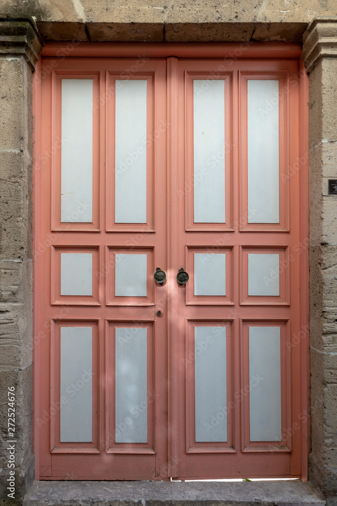 Vintage rose pink door of the old stone house