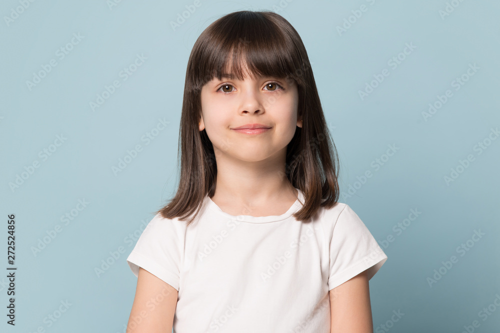 © fizkes - Little girl looking at camera isolated on blue studio background © fizkes - Little girl looking at camera isolated on blue studio background