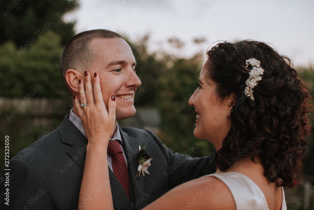 © Leah Flores/Stocksy - Affectionate Bride and Groom Looking at each Other
