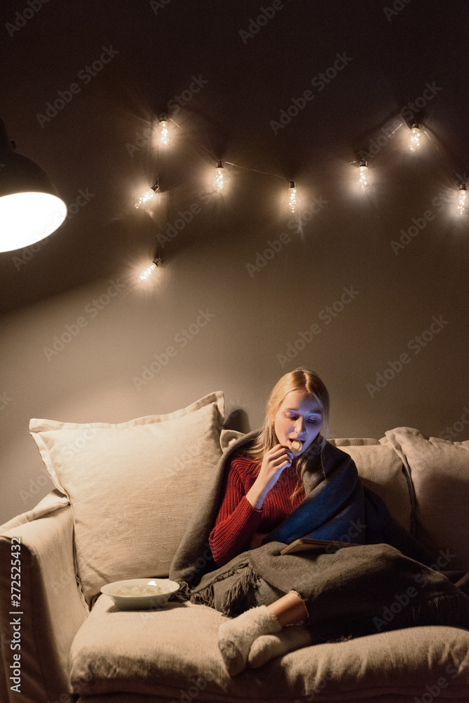 Woman enjoying evening with tablet and chips Woman enjoying evening with tablet and chips