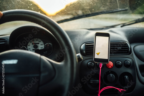 travel driving a car in the summer, the navigator in the smartphone. the driver is driving