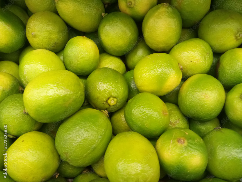 fresh green lime fruits on the market in a box fresh green lime fruits on the market in a box