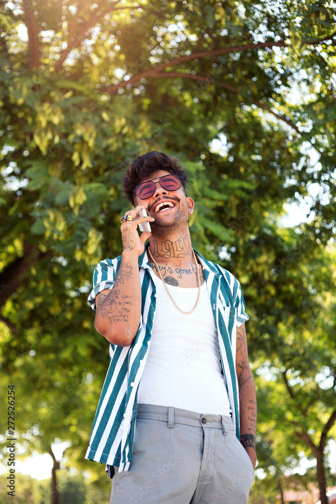 Tattooed man on the phone. Tattooed man on the phone.