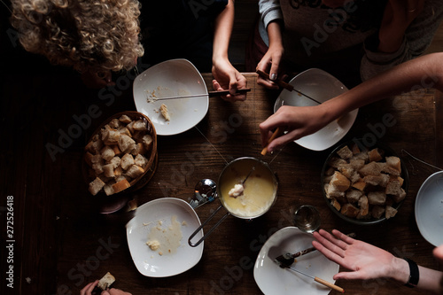 group of teen eating cheese fondue