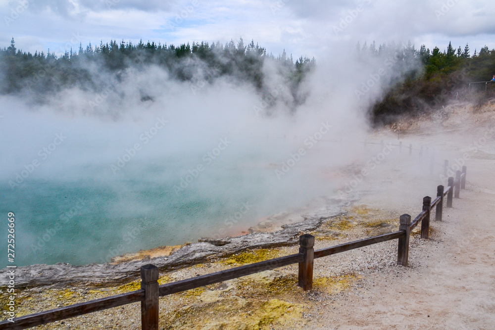 Fototapeta premium View of colorful steaming volcanic Champagne pool in geothermal Wai-O-Tapu wonderland in Rotorua, North Island, New Zealand. Tourist popular unique natural attraction. 