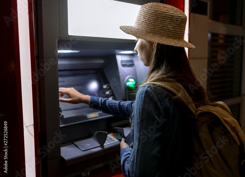 Woman using ATM on street
