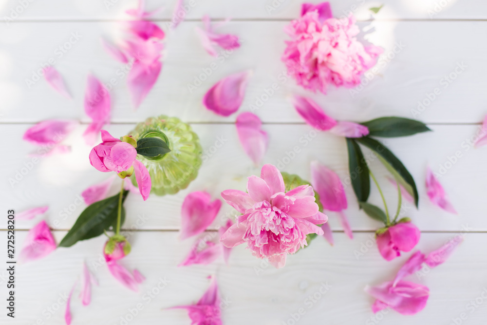Obraz premium Beautiful soft pink peonies in vase on white wooden background outdoors. Summer flowers in blossom. Nature, fresh pink flowers concept