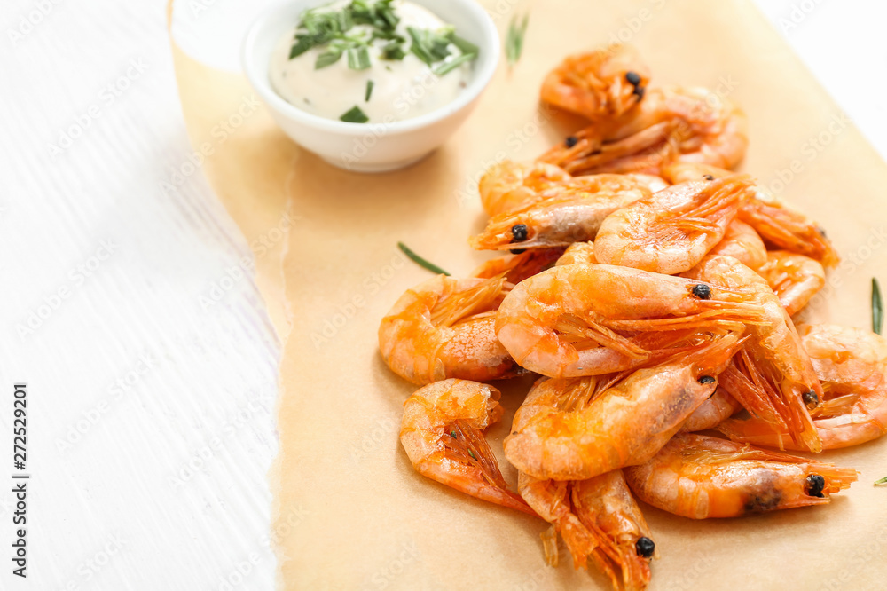 Tasty shrimps with sauce on white table Tasty shrimps with sauce on white table