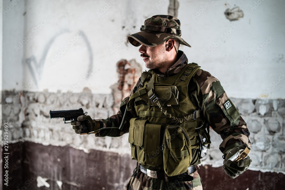Military soldier dogs of war crime terrorist in the ruined building holding gun and hand grenade mercenary Military soldier dogs of war crime terrorist in the ruined building holding gun and hand grenade mercenary