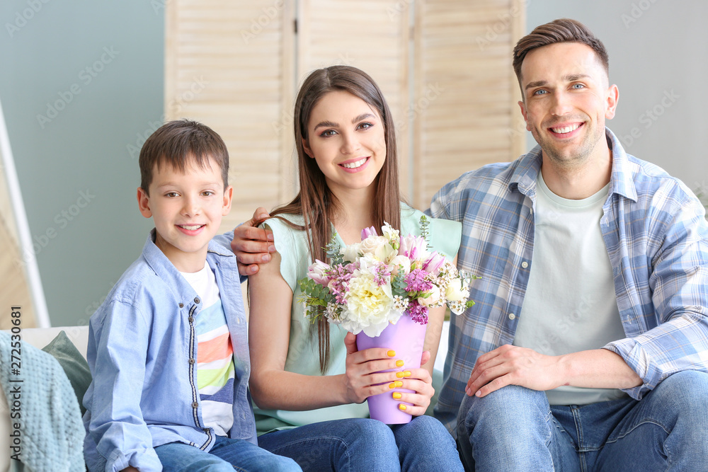 Happy family with bouquet of beautiful flowers at home Happy family with bouquet of beautiful flowers at home